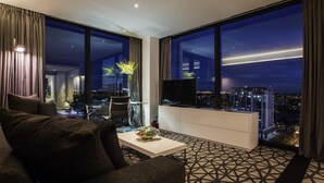 A modern hotel room with a large window offering a city view at night. - Pullman Sydney Airport (Mascot)