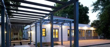 A covered outdoor area with a building in the background.