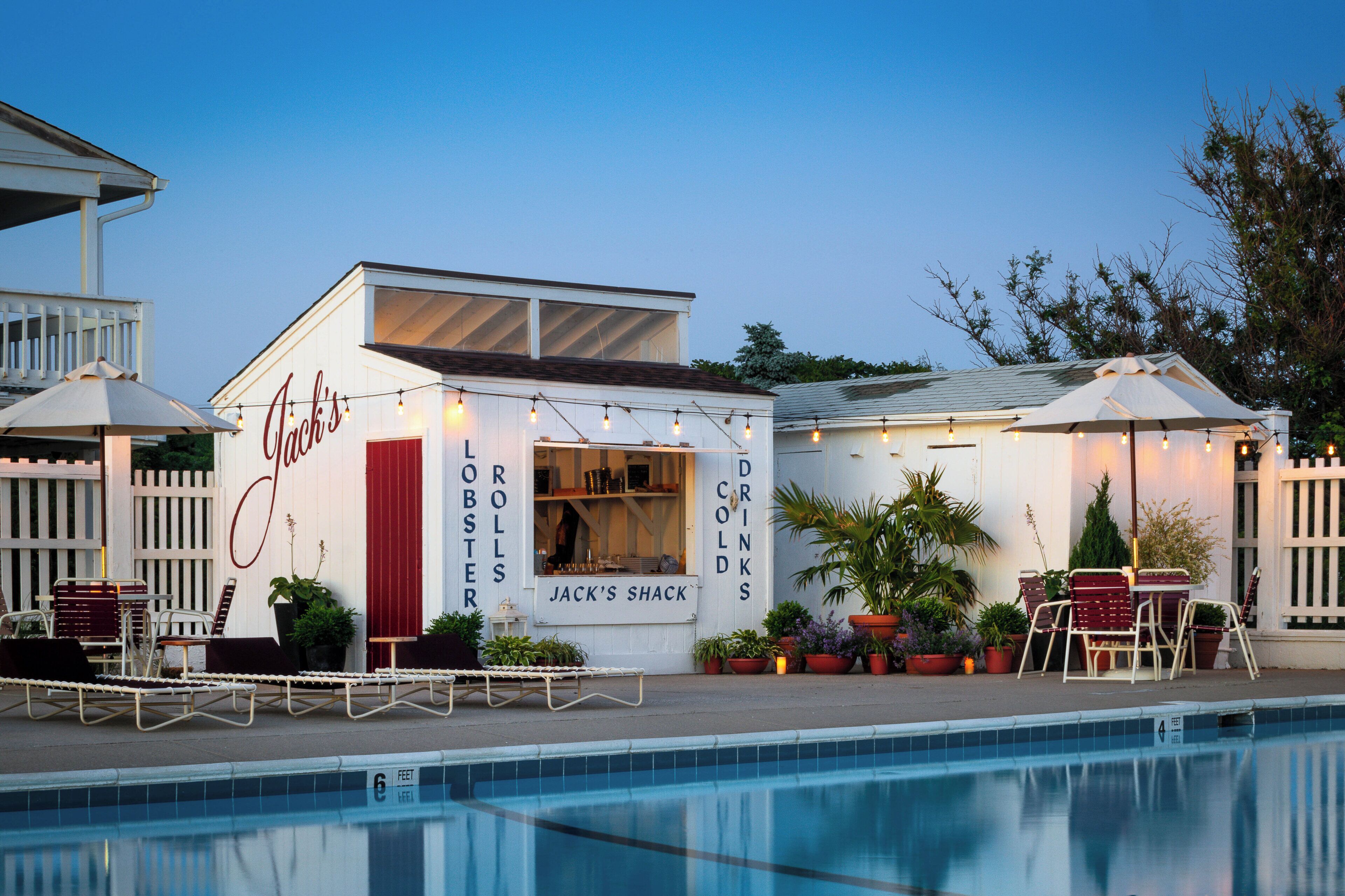 A poolside bar named "Jack's Shack" with outdoor seating and a view of the pool.