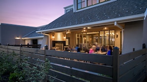A restaurant with outdoor seating, a covered patio, and a fireplace. - The Inn at Swarthmore (Swarthmore)