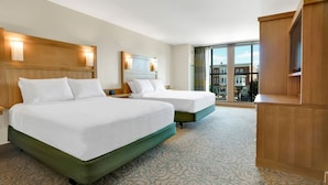 A hotel room with two beds, a large window with a city view, and a wooden cabinet. - The Inn at Swarthmore (Swarthmore)