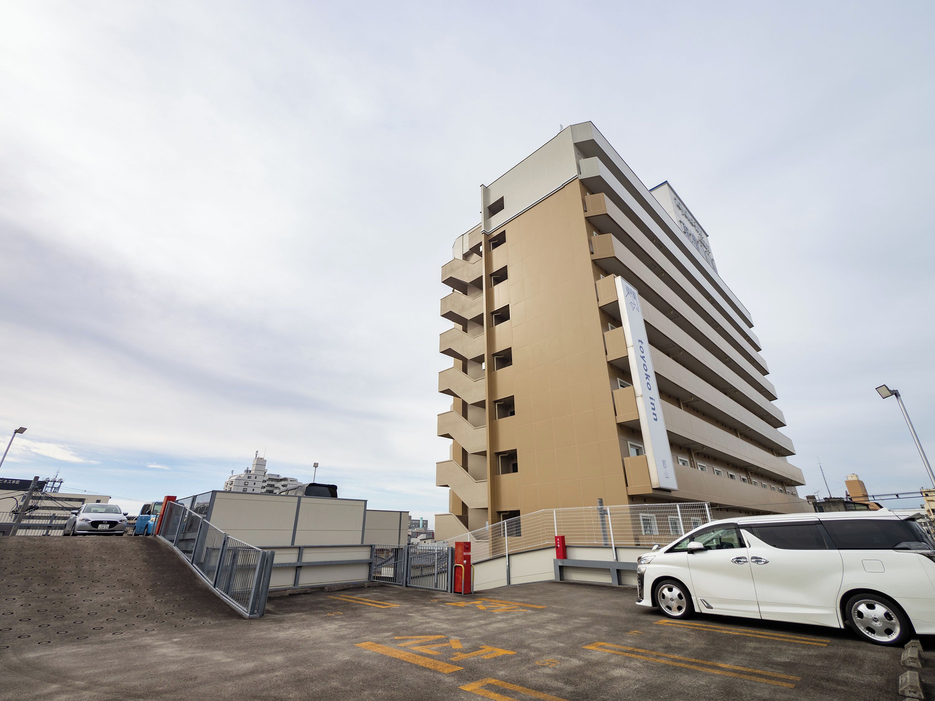 A multi-story building with a sign indicating it is a Toyota Inn.