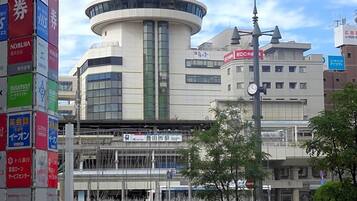 A modern building with a circular central section, surrounded by commercial signage.