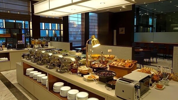 A buffet setup with various food items, a coffee machine, and a toaster. - Hotel Toyota Castle (Toyota)