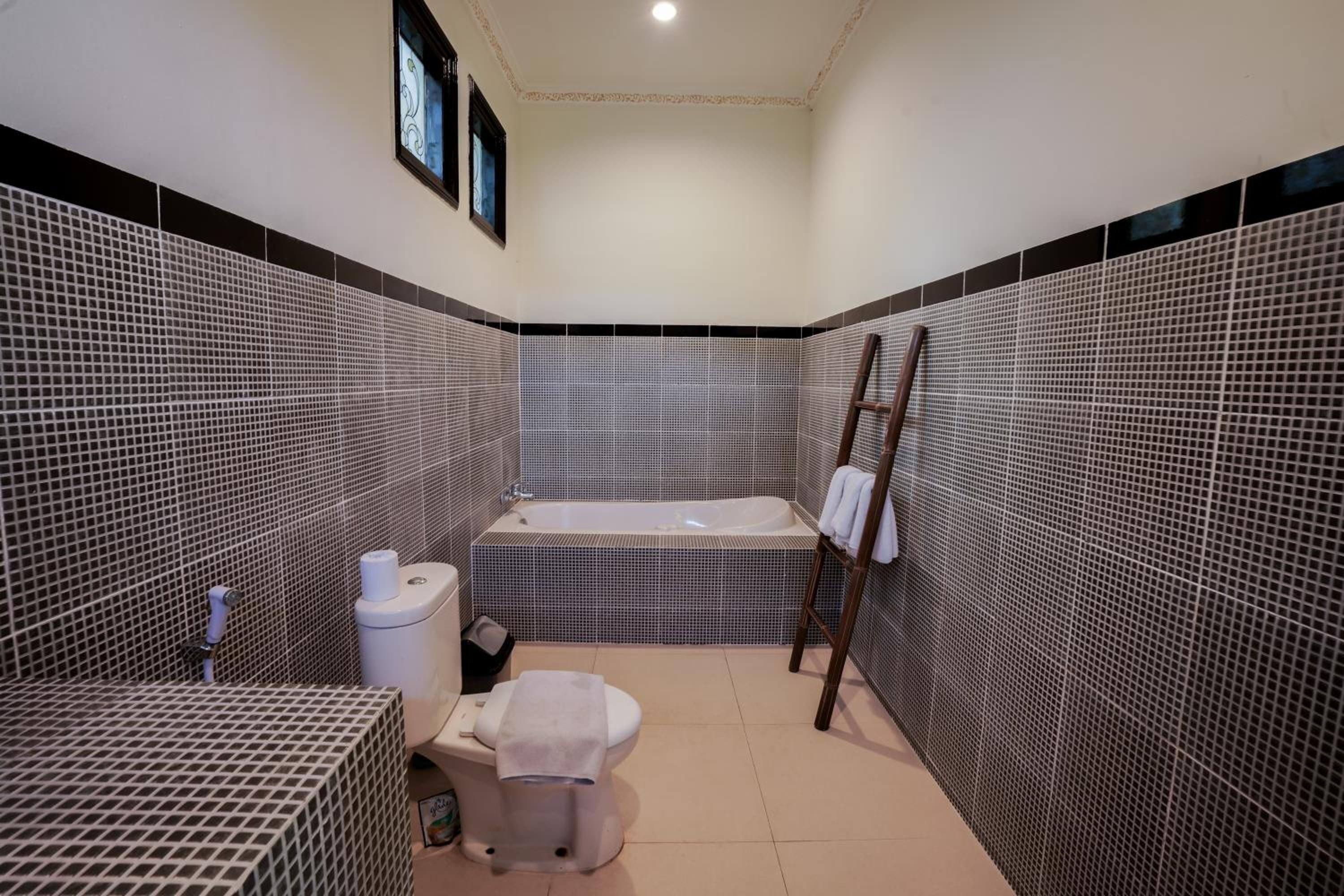 A bathroom with a bathtub, toilet, and sink.