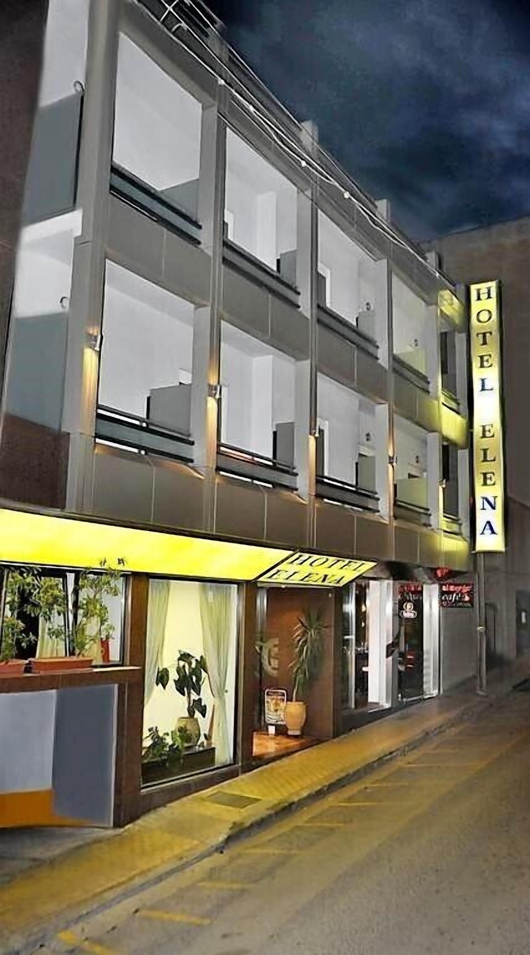 A hotel with a modern facade, multiple floors, and a prominent sign.