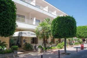 A hotel with a white facade, outdoor seating, and well-maintained landscaping. - Gaya (Calvia)