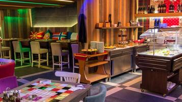 A restaurant with a checkered floor, wooden panel walls, and a buffet area with various food items.
