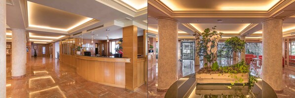 A hotel lobby with a reception desk, marble flooring, and a central column with plants. - Jaime I (Benidorm)