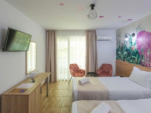 A hotel room with a bed, a desk, a chair, a television, and a window with curtains. - ibis Styles Venus (Opening June 2024) (Venus)