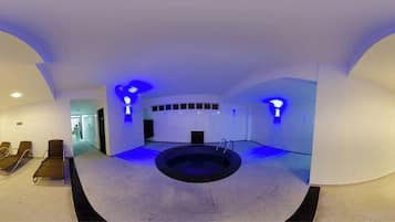 Relax in a serene, self-contained space with a central hot tub or pool surrounded by lounge chairs.