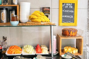 A breakfast buffet with various fruits, pastries, and a chalkboard menu. - I-Hotel, Piracicaba (Piracicaba)