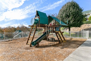 Children can play on the slide and climb the structure in this playground.