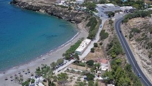 An aerial view of a coastal area with buildings, a swimming pool, and a beach. - Avra Palm (Ierapetra)