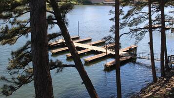 A lake with wooden docks and a building in the background.