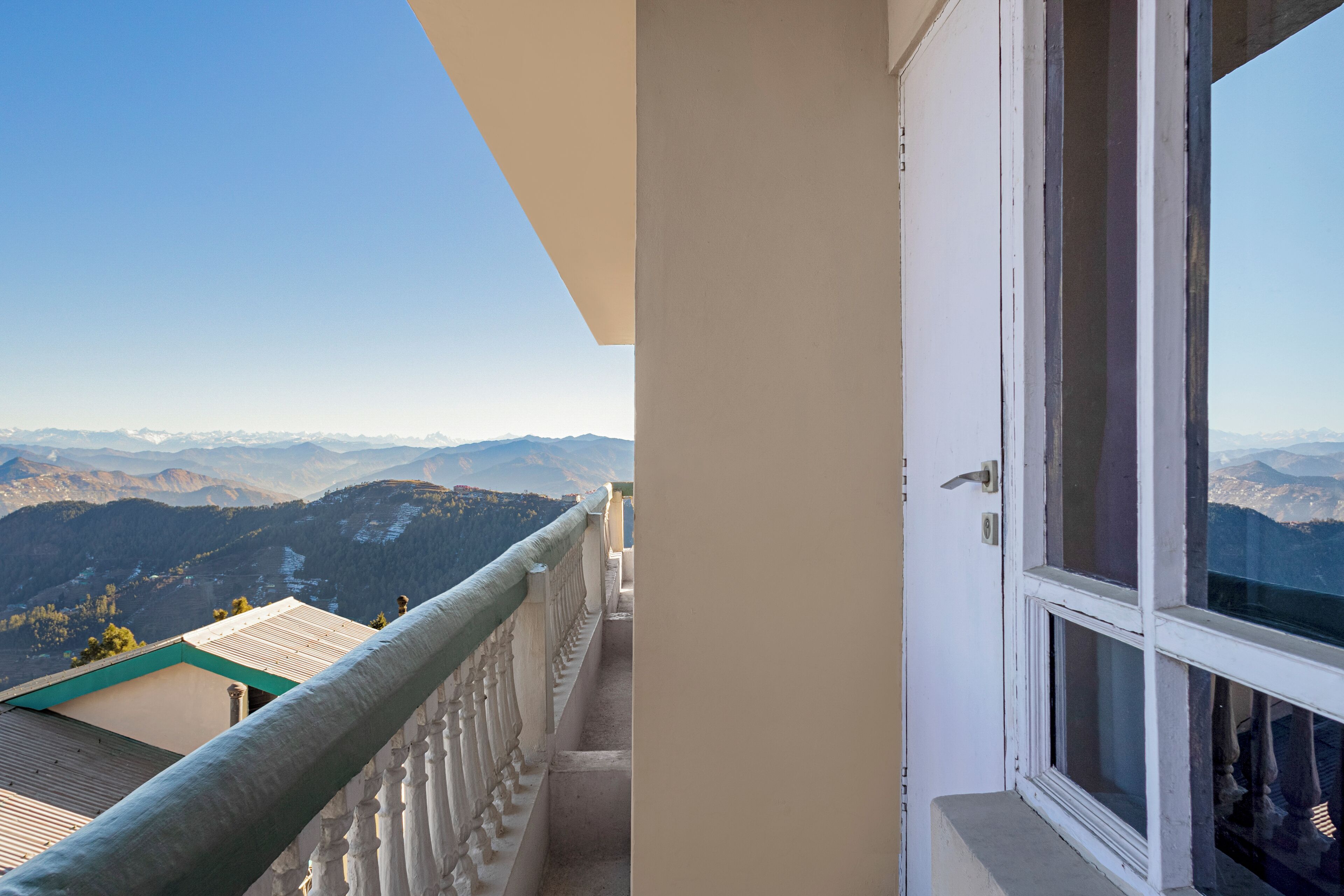 A balcony with a view of snow-capped mountains.