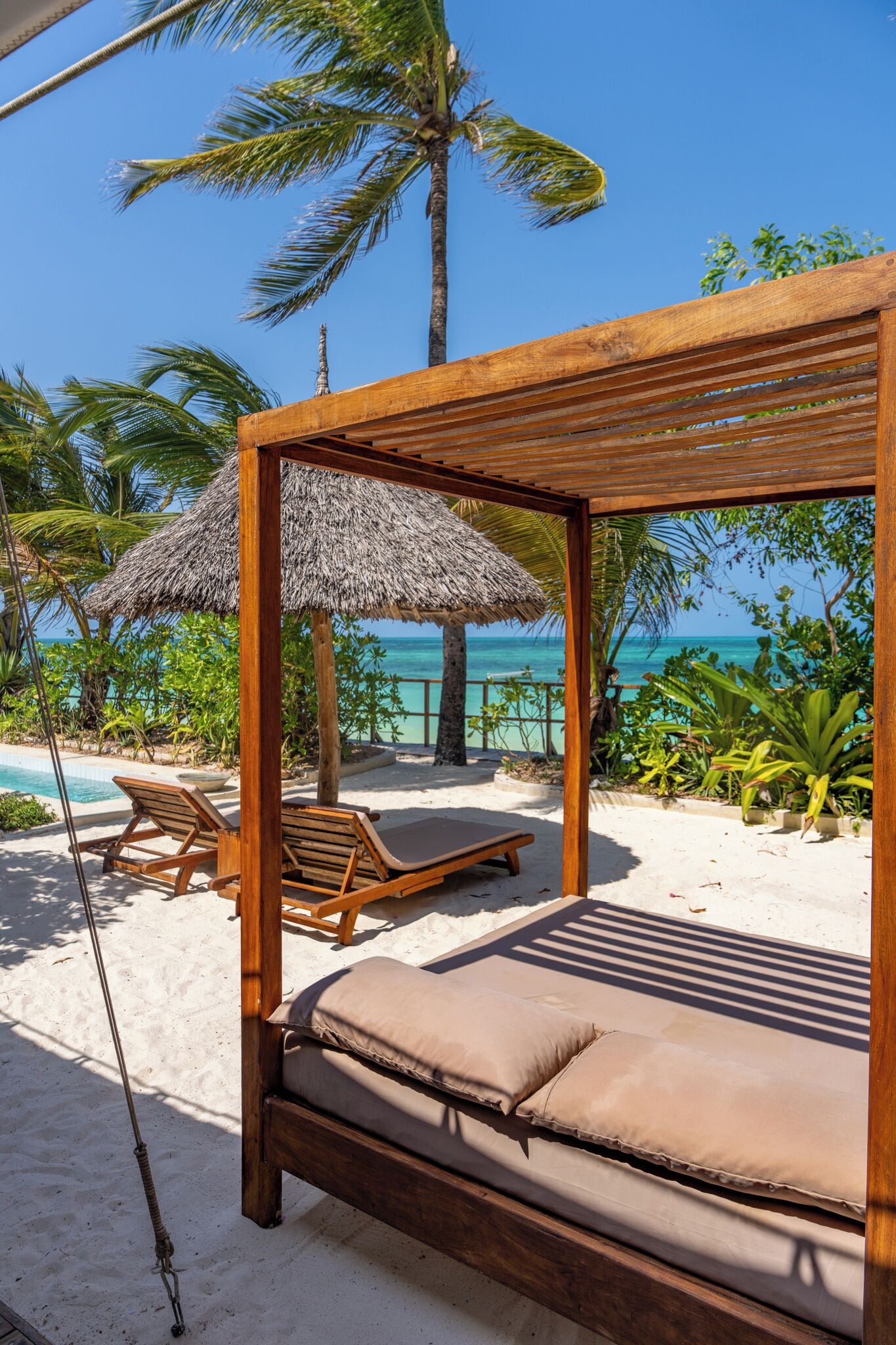 On the beach, white sand, sun-loungers, beach umbrellas