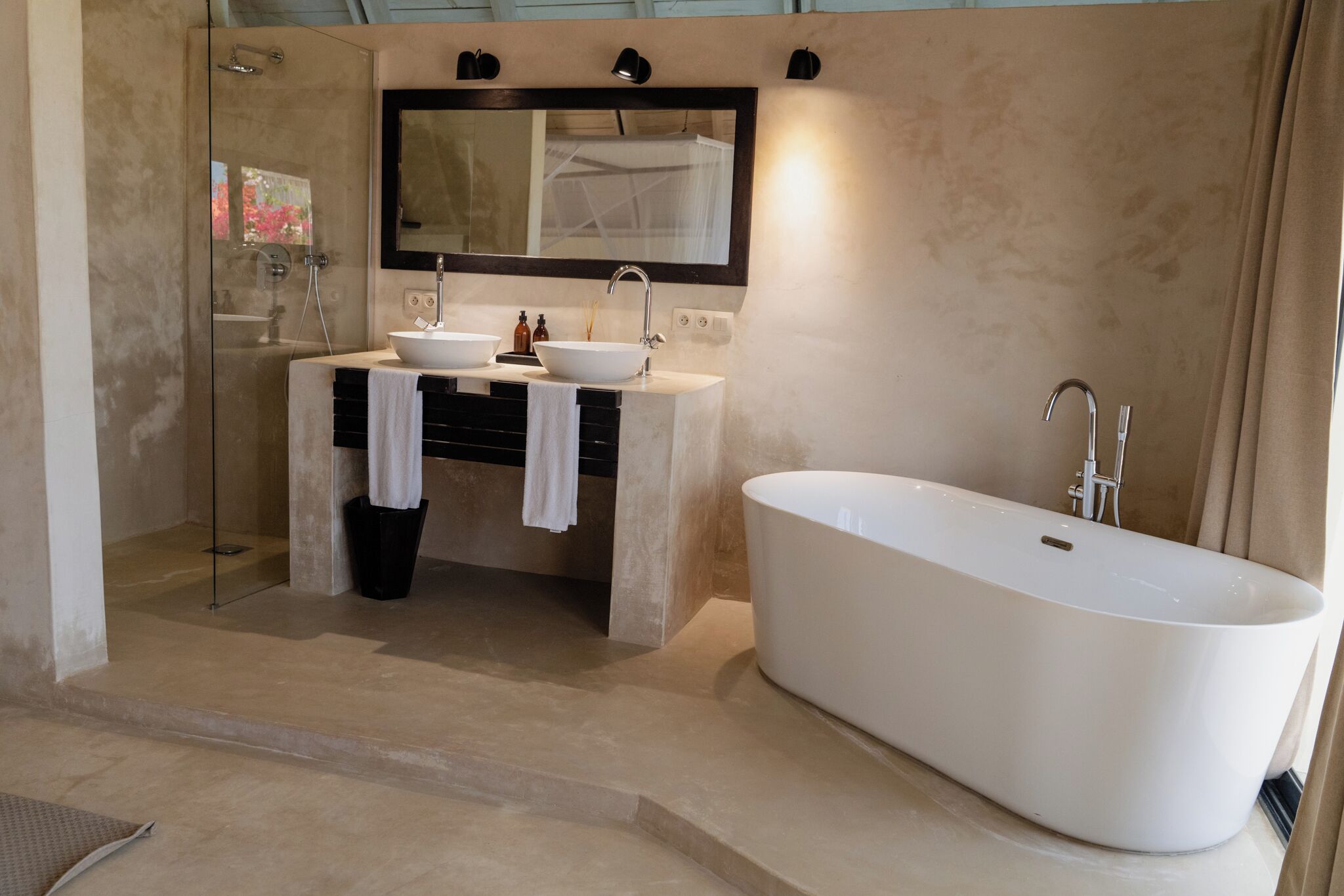 Une salle de bain moderne avec une baignoire sur pieds, un meuble-lavabo à deux vasques et une douche à parois de verre.