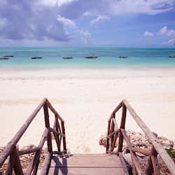 On the beach, white sand, sun loungers, beach umbrellas