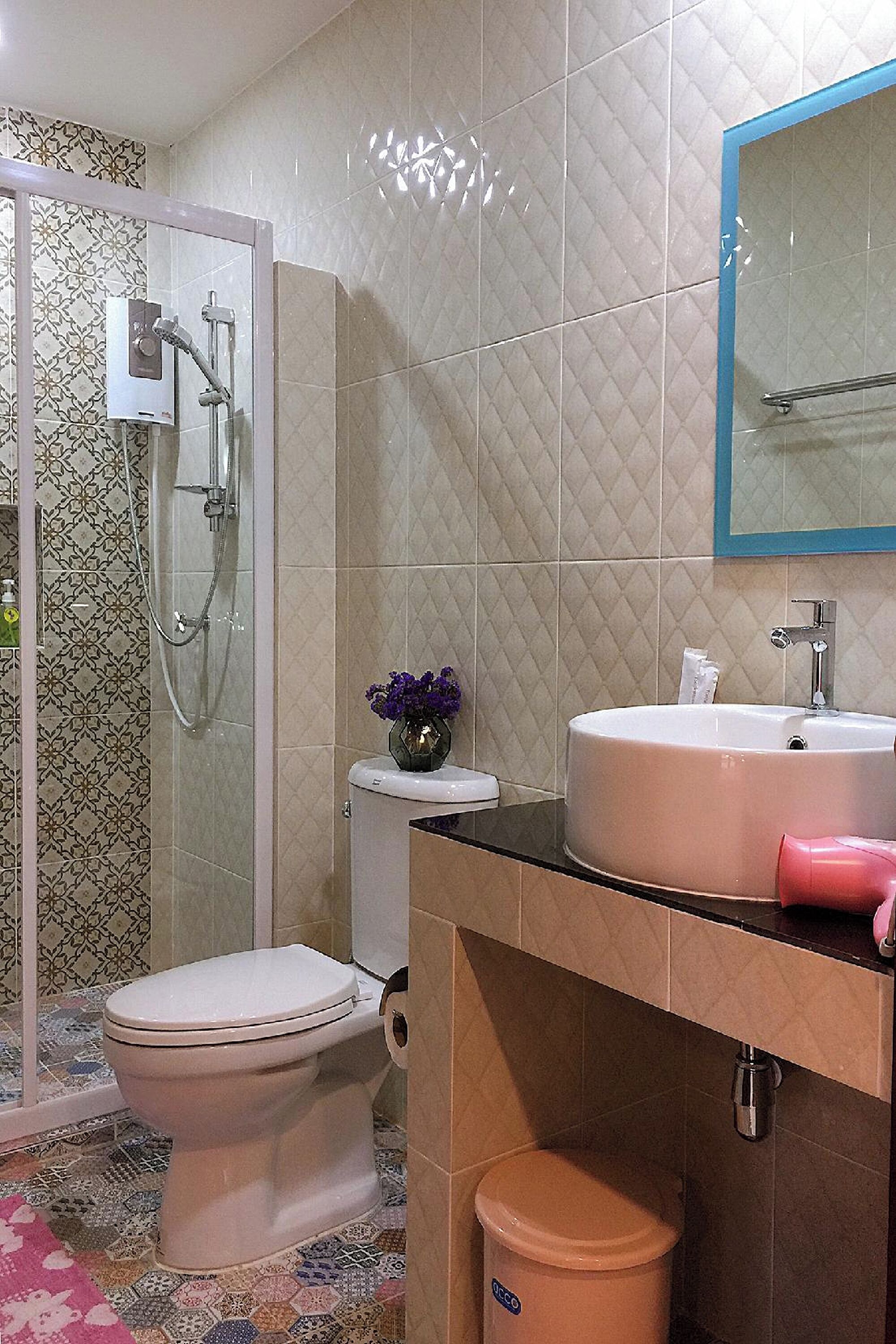 A bathroom with a toilet, sink, and shower.
