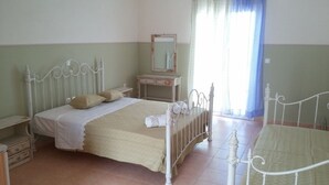 A bedroom with a bed, a nightstand, a dresser, and a mirror. - Elaias Gi Residence (Kefalonia)