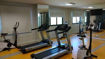 A gym with treadmills, ellipticals, and stationary bikes.