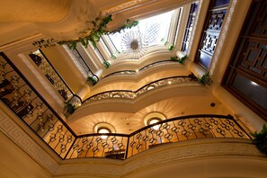 A grand, multi-level interior with ornate railings and decorative ceiling patterns. - Black Bird Thermal Hotel & Spa (Termal)