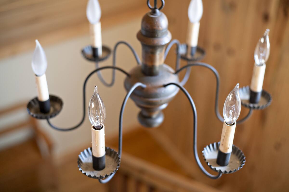 A chandelier with multiple candle-like lights and a central ornate fixture.
