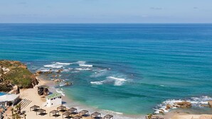 A coastal hotel with a beach view, a pool area, and a small building near the shore. - Resort Hadera Hotel By Jacob (Hadera)
