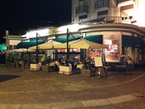 Relax in the charming outdoor seating area of Le Conte, where tables and chairs are shaded under large umbrellas.