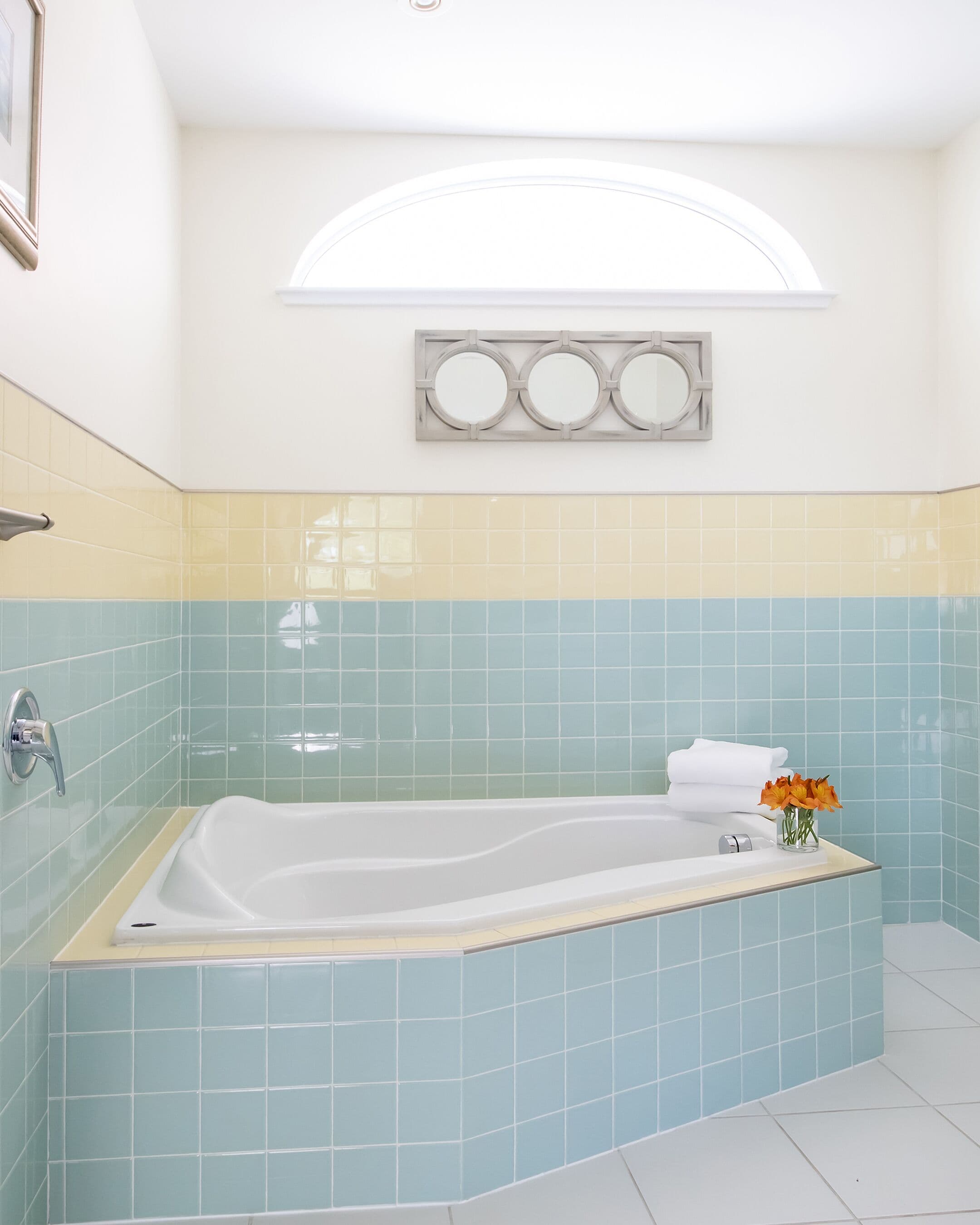 A bathroom with a freestanding bathtub, a shower, and a vanity with a mirror.