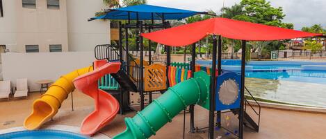 A children's play area with multiple slides and a pool.