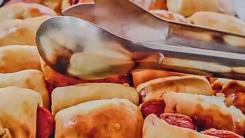 A tray of pastries with a spoon on top.