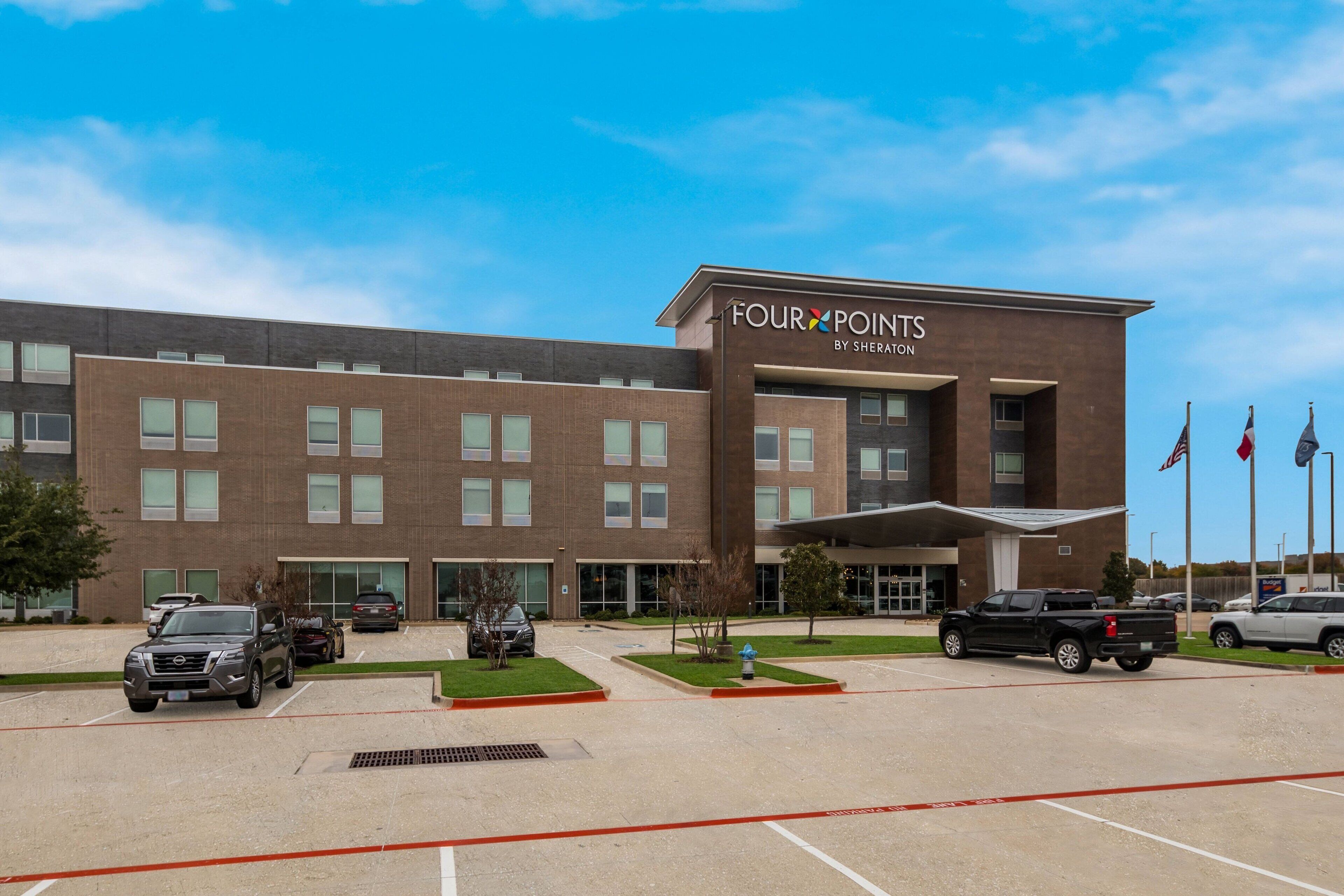 A modern building with a sign reading "Four Points by Sheraton."