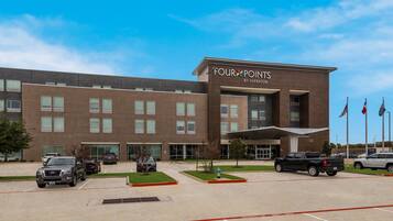 A modern building with a sign reading "Four Points by Sheraton."