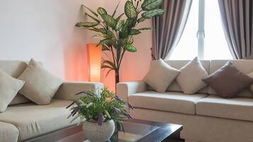 Deluxe Apartment, 3 Bedrooms | Living room | 32-inch flat-screen TV with cable channels, TV, table tennis