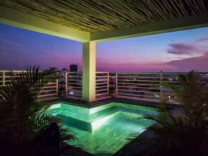 A rooftop pool with a view of the city skyline at dusk. - La Belle Residence (Phnom Penh)