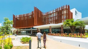 A modern building with a unique facade, a central entrance, and a sign for the 'INGARUMING ART CENTRE'. - Cairns City Palms (Cairns North)