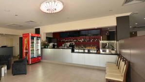 A modern hotel lobby with seating areas, a Coca-Cola refrigerator, and a bar counter. - Parklane Motel Murray Bridge (Murray Bridge)