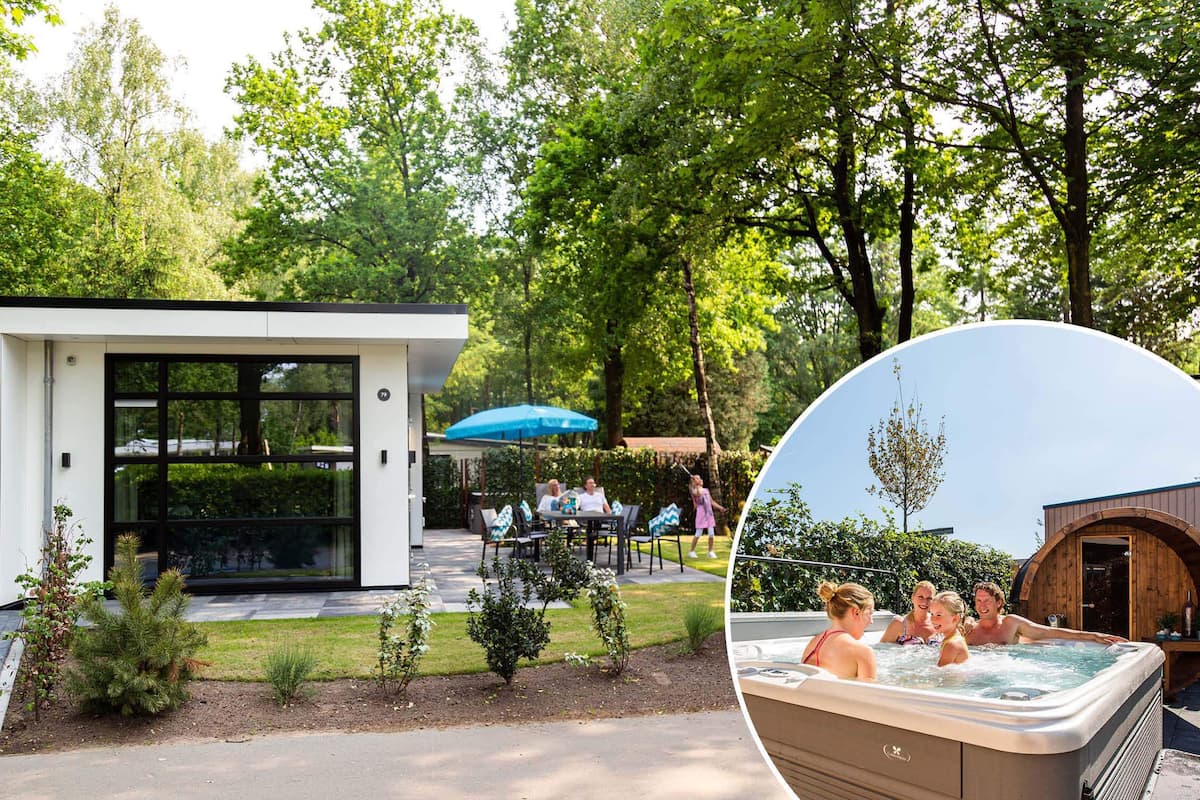 A modern outdoor seating area with a glass enclosure, a hot tub, and a wooden structure.