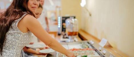 A buffet with various food items.