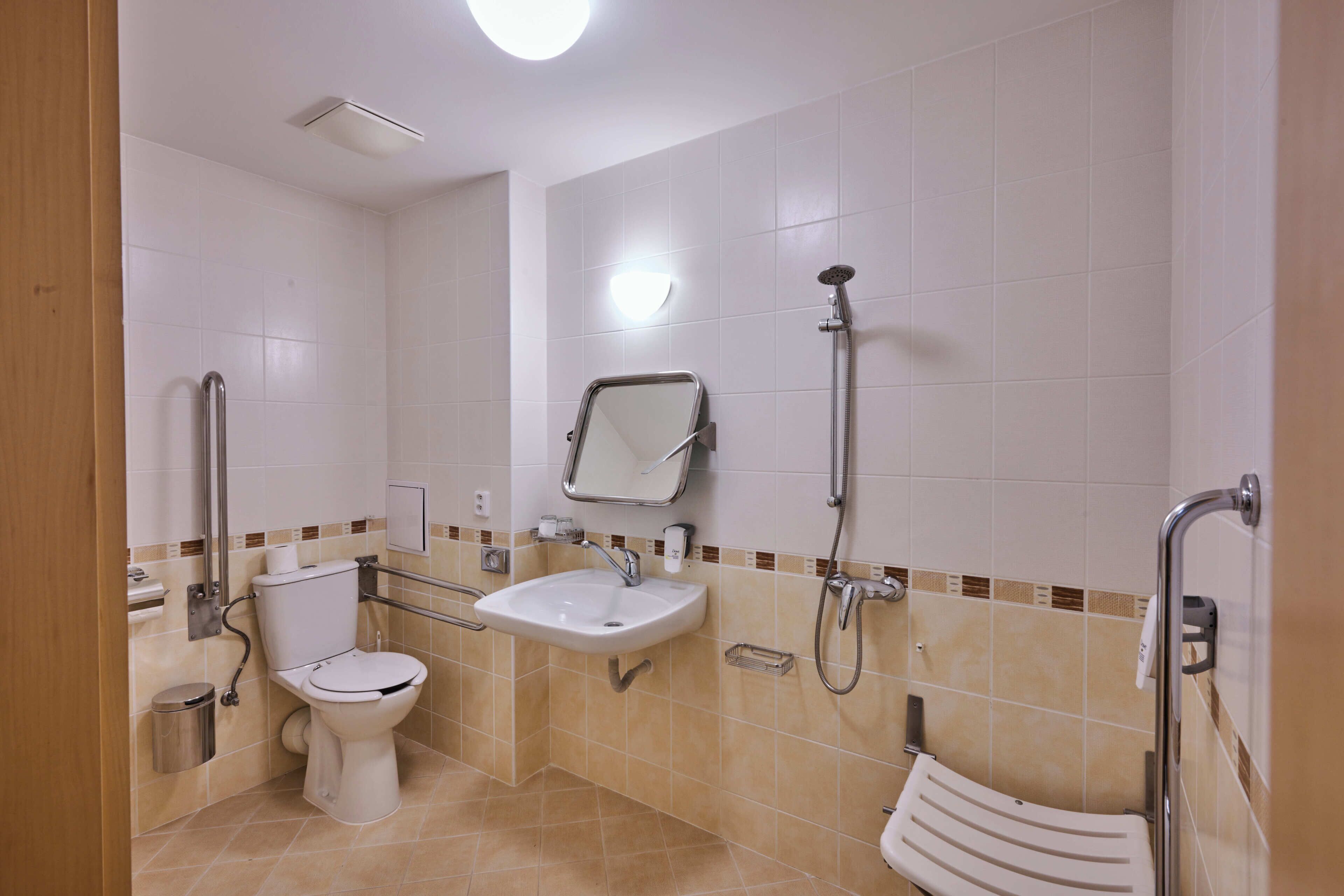 A bathroom with a toilet, sink, and shower.