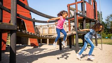 Children can play on the climbing frame and slide in this outdoor playground.