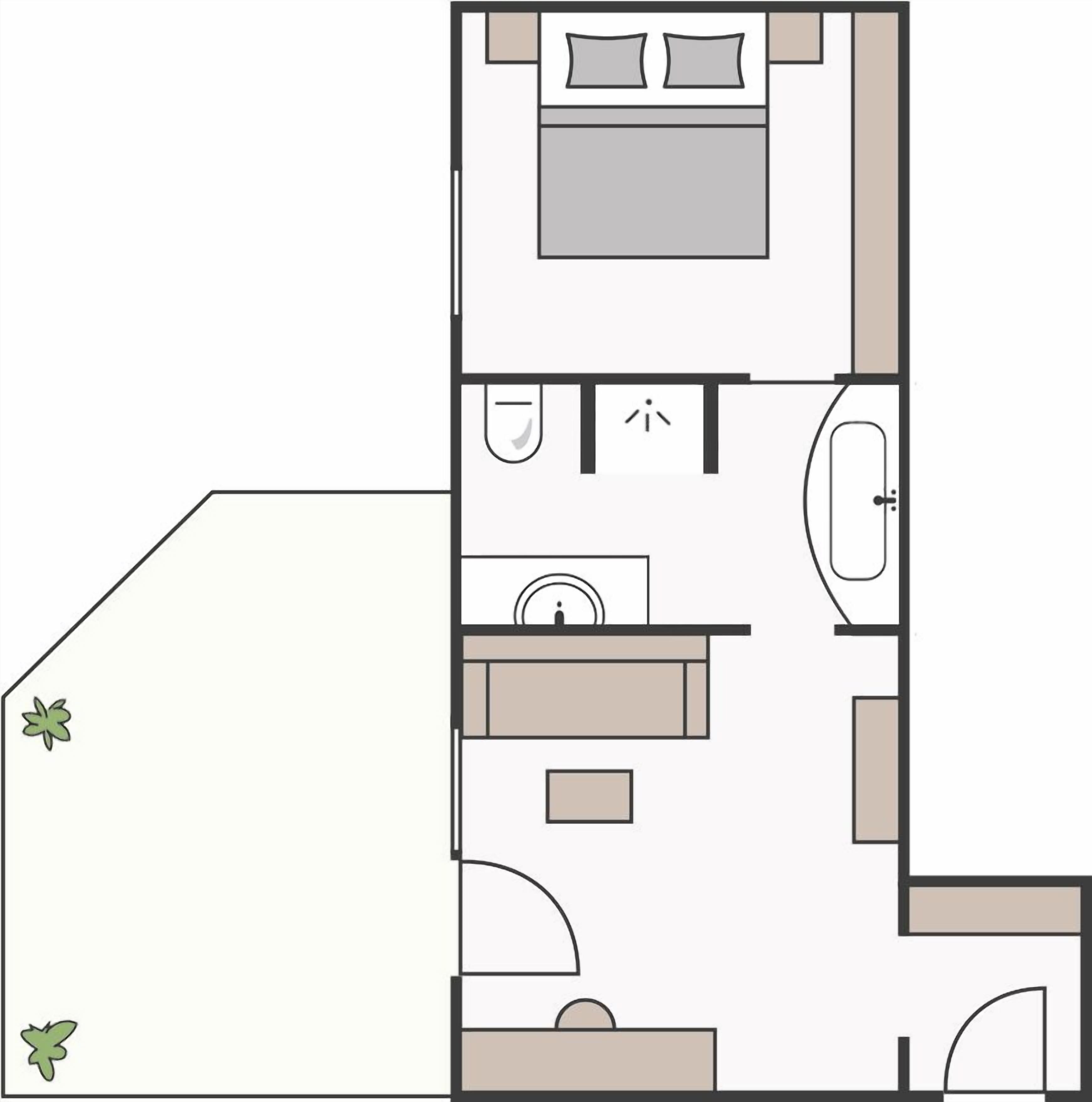 En planritning över ett hotellrum med en säng, ett badrum, ett handfat och en liten sittgrupp.