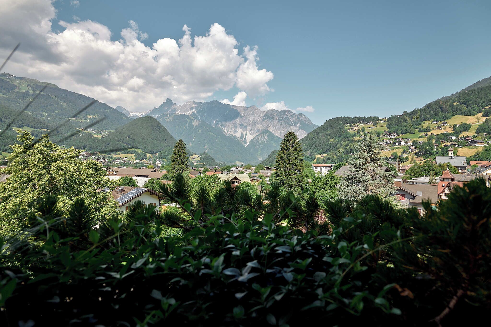 A mountainous landscape with a village nestled in the valley.