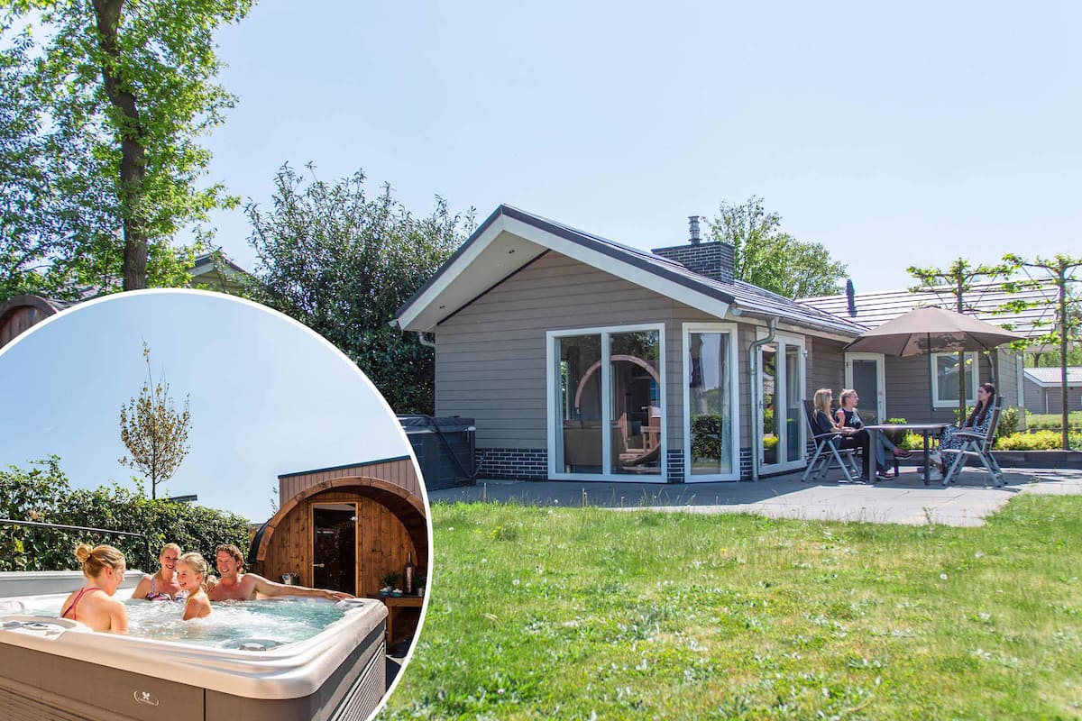 A house with a hot tub, a patio with chairs, and a covered outdoor area.