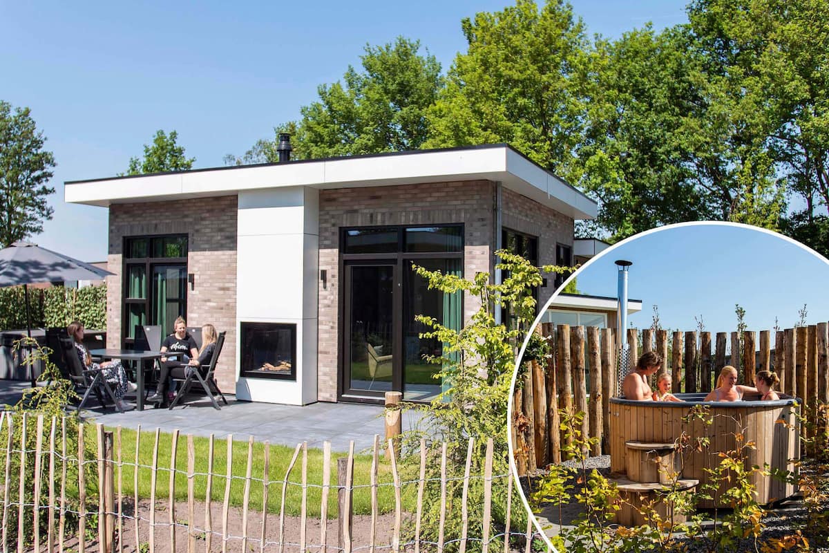 A modern outdoor patio area with a dining table and chairs, a wooden fence, and a hot tub.