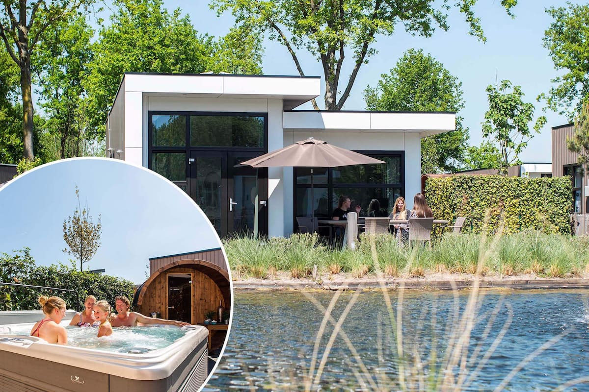 A modern building with large windows, a patio area with outdoor seating, and a hot tub.