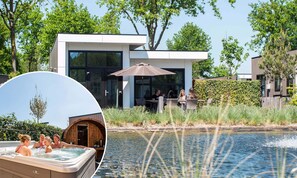 A modern building with large windows, a patio area with outdoor seating, and a hot tub. - TopParken Résidence de Leuvert (Cromvoirt)