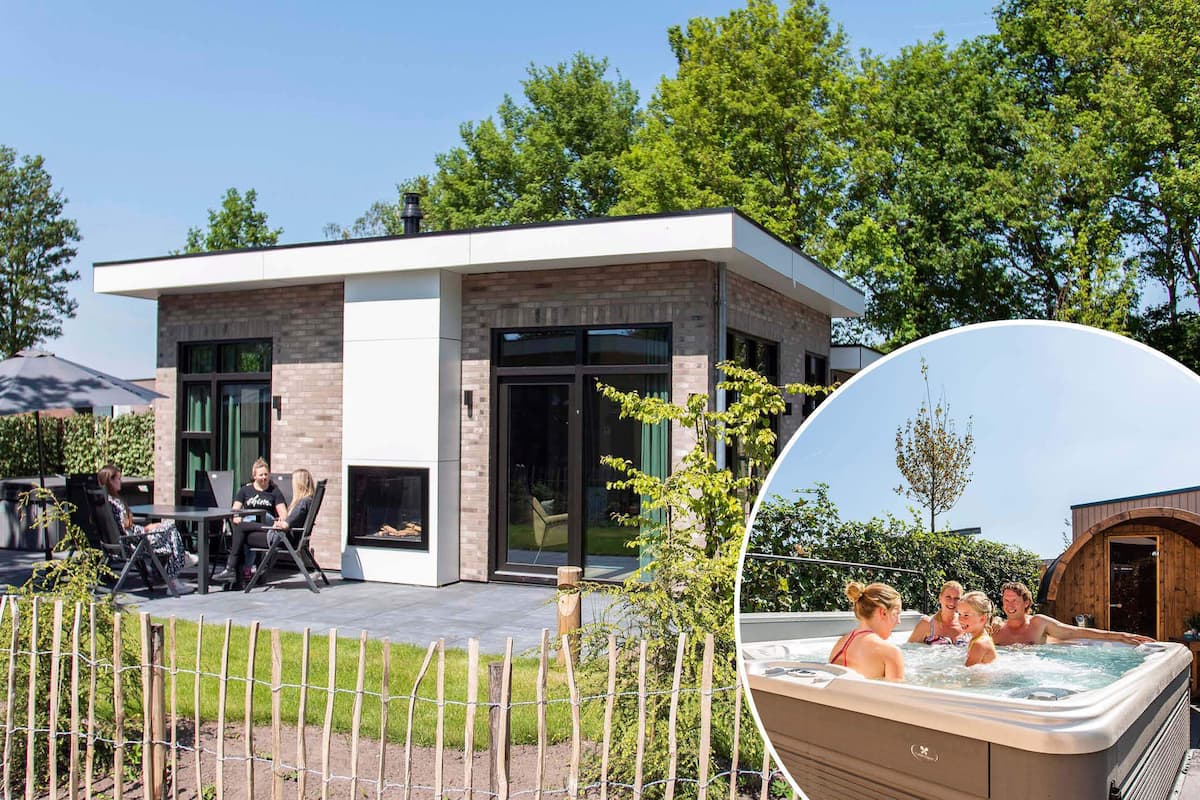 A modern house with a patio, a hot tub, and a fenced garden area.
